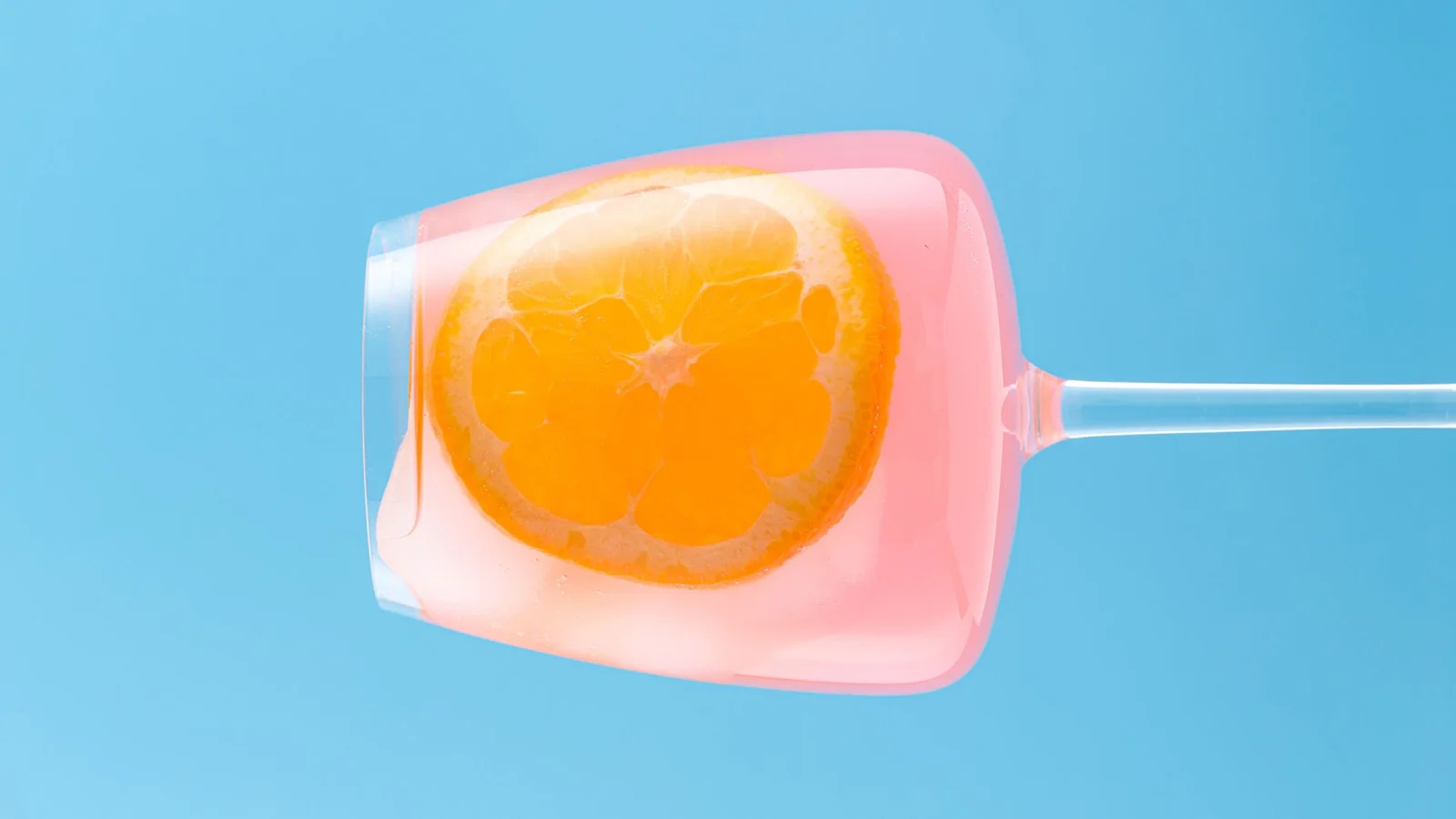 Pink drink with orange on a blue background